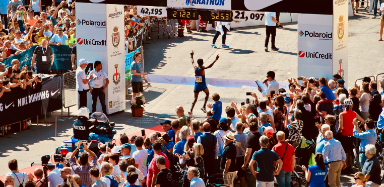 Crowd cheering marathon finisher